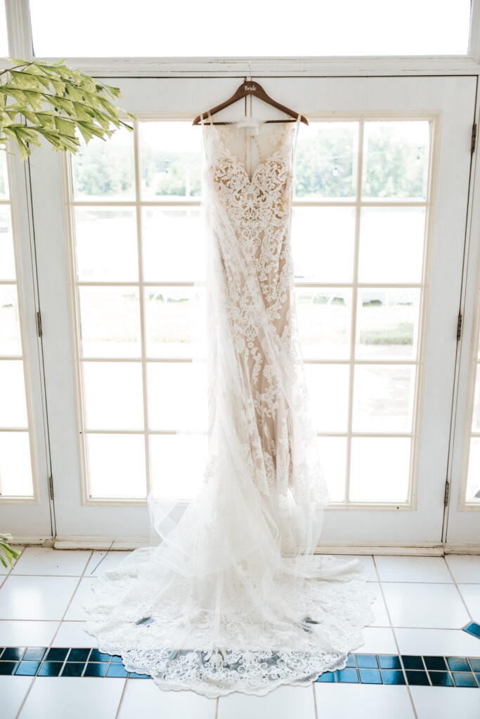 Wedding Dress in front of french doors with windows